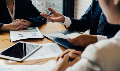 Asian business adviser meeting to analyze and discuss the situation on the financial report in the meeting room.Investment Consultant,Financial Consultant,Financial advisor and accounting concept