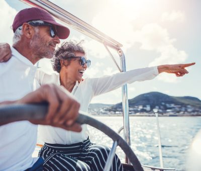 Happy senior couple having fun on a boat trip