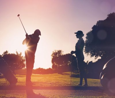 Composite image of golfing couple playing together